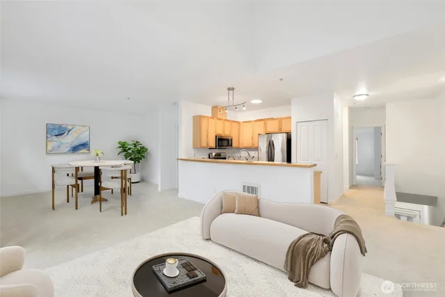 a living room with furniture kitchen view and a table