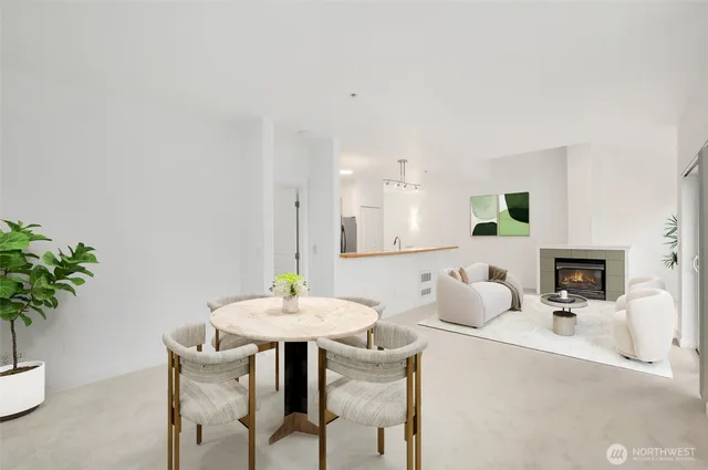a view of a dining room with furniture and a potted plant