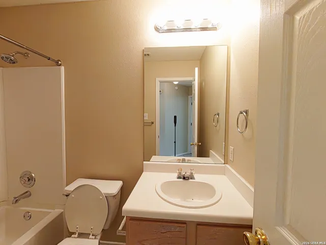 a bathroom with a toilet and a bathtub