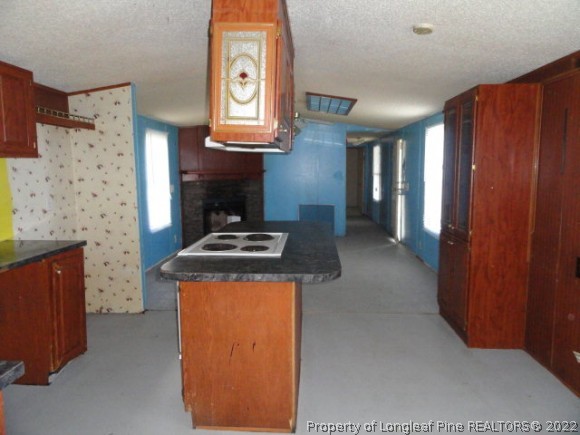 a kitchen with stainless steel appliances granite countertop a stove and a refrigerator