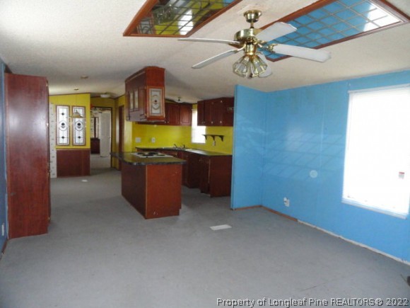 240 Youngs Road Vass, NC 28394 - Photo 2 of 8 a room with a chandelier fan and windows