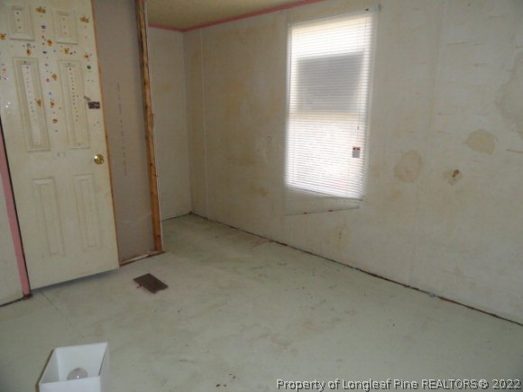 240 Youngs Road Vass, NC 28394 - Photo 6 of 8 a view of an empty room with a window