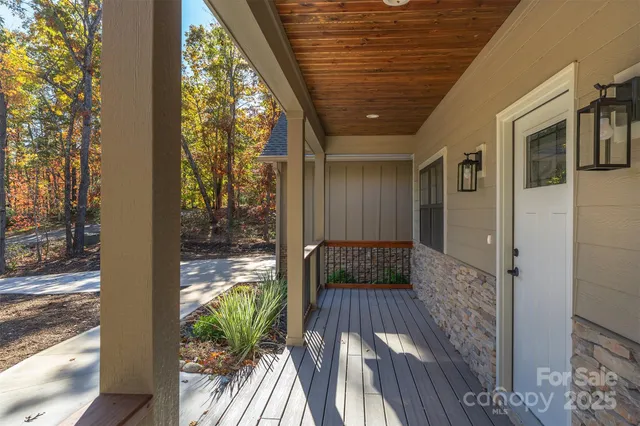 a view of a roof deck with wooden floor and fence