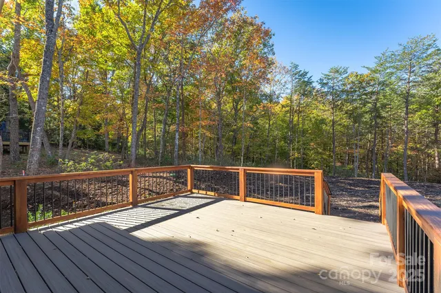 an empty room with a window and a ceiling fan