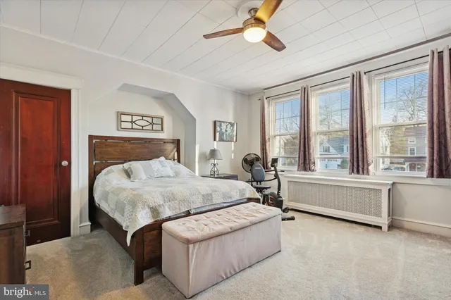 a bedroom with a large bed and a large window