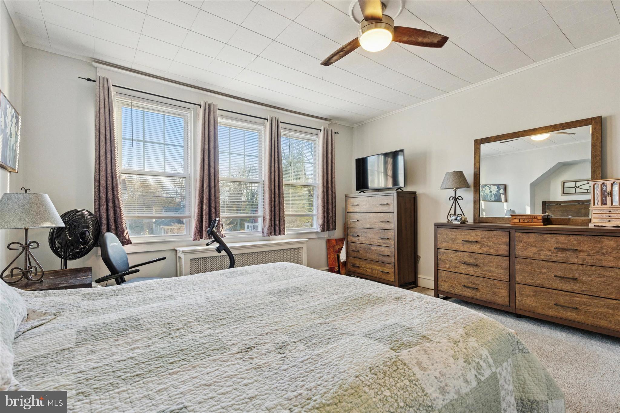 6329 East Valley Green Road Flourtown, PA 19031 - Photo 14 of 23 a bedroom with a bed a large window and flat screen tv