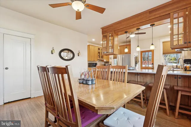 a view of a dining room with furniture wooden floor and chandelier