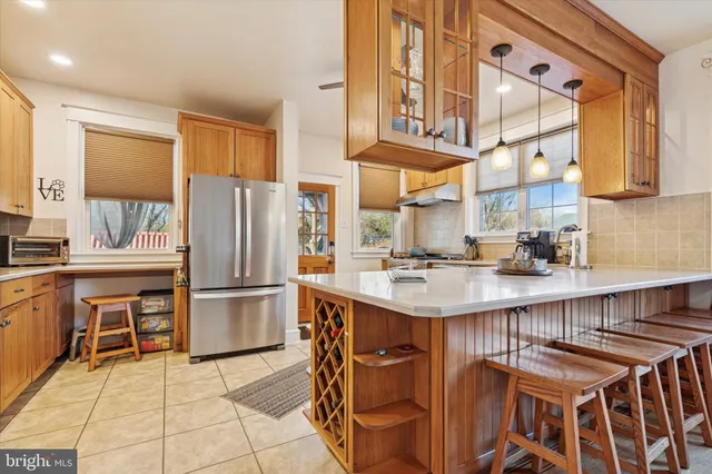 a kitchen with kitchen island a large counter top space appliances and cabinets