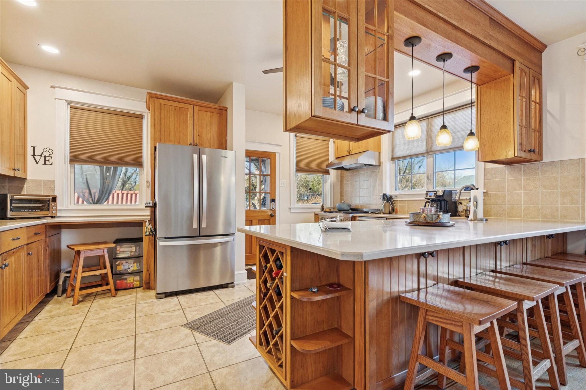6329 East Valley Green Road Flourtown, PA 19031 - Photo 9 of 23 a kitchen with kitchen island a large counter top space appliances and cabinets