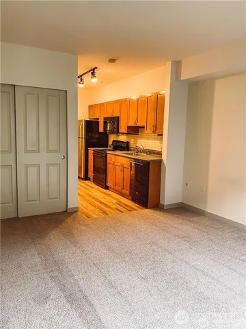 a view of a kitchen with a sink and a refrigerator