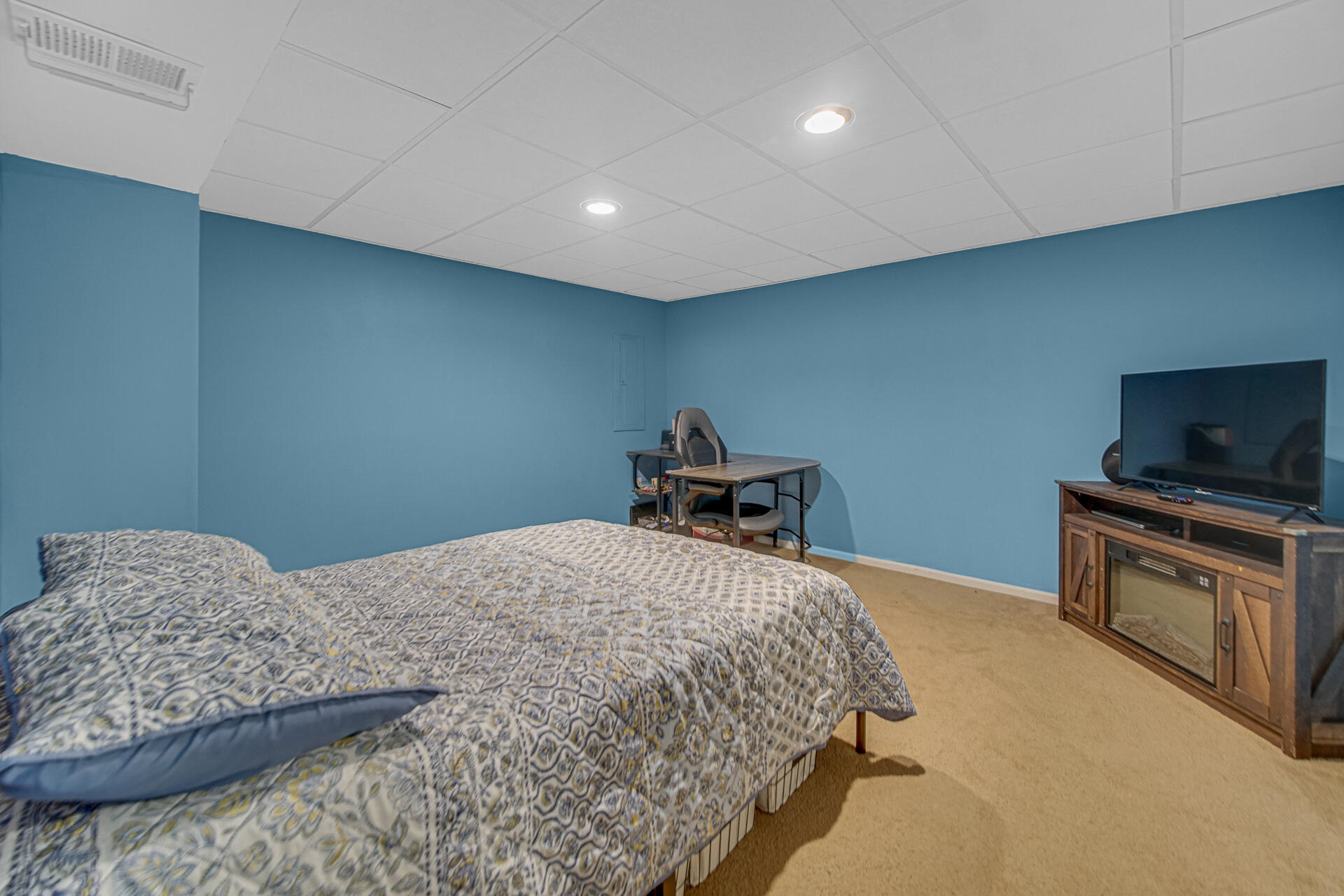 4942 West 93rd Court Crown Point, IN 46307 - Photo 25 of 37 a bedroom with a bed and a flat screen tv