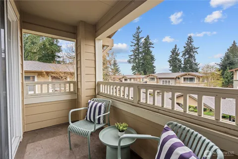a balcony with chairs and a table