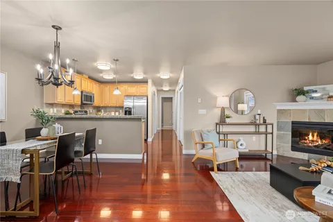 a view of a dining room with furniture a chandelier and wooden floor