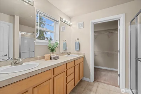a bathroom with a double vanity sink mirror and