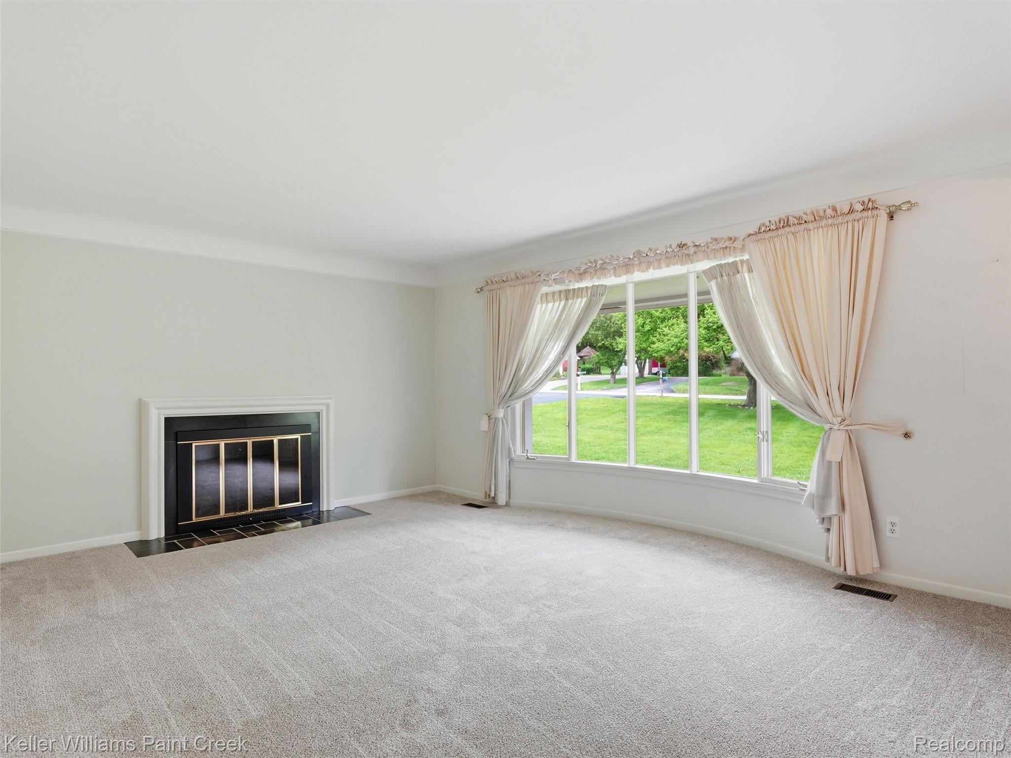 436 Broadleaf Drive Rochester, MI 48306 - Photo 11 of 41 Unfurnished living room with carpet and a fireplace with flush hearth