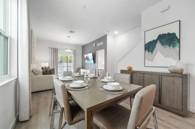 a view of a dining room with furniture and wooden floor