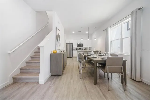 a dining room with furniture and wooden floor