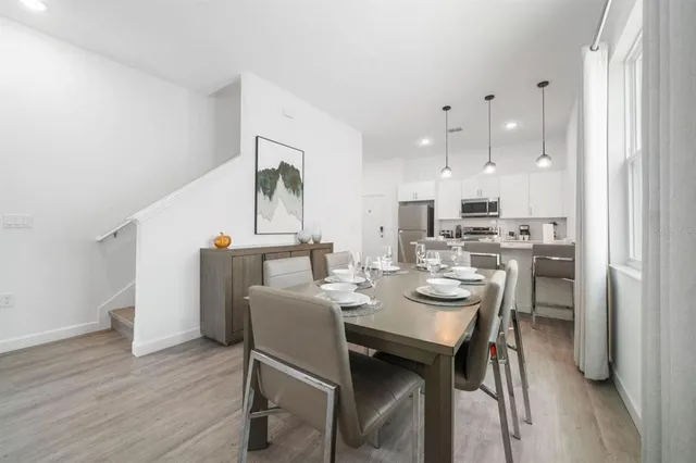 a dining room with kitchen island a table and chairs