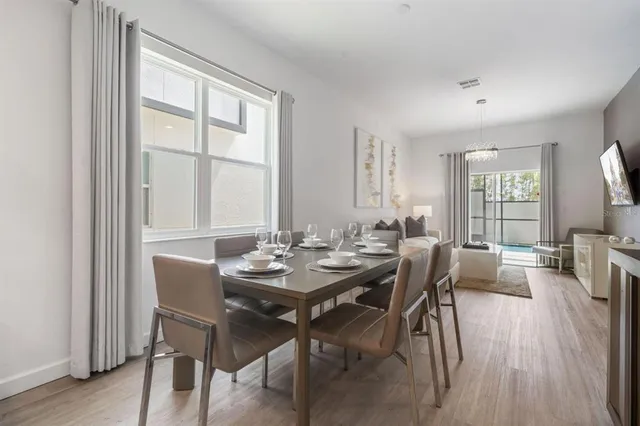 a view of a dining room with furniture and wooden floor