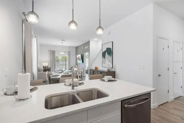 a kitchen with a sink and chandelier