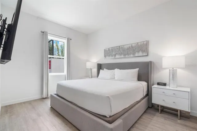 a bedroom with a bed and a window