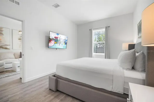 a bathroom with a double vanity sink a mirror and a bathtub