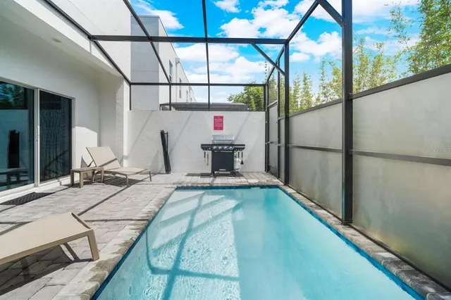 a living room with a bed and large windows
