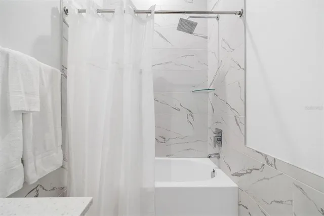 a bed room with a bed and a window