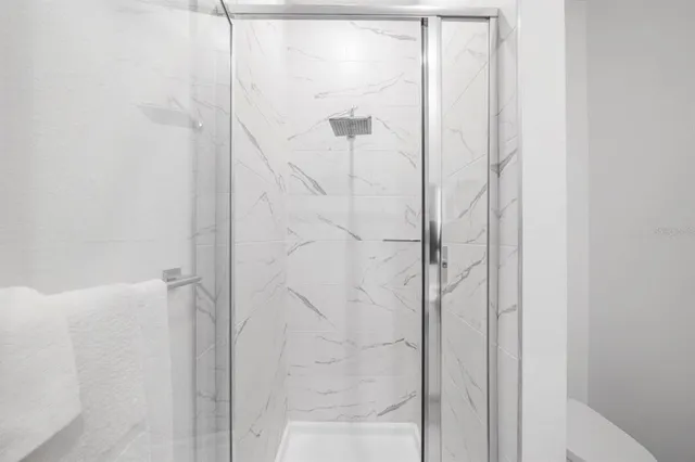 a bedroom with a bed and a lamp on dresser