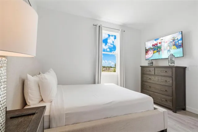 a bed room with a bed and a night stand