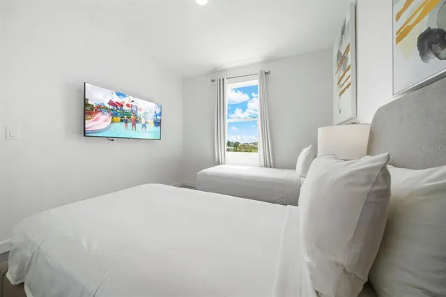 a bedroom with two beds and a window