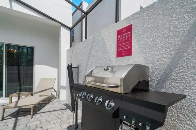 a view of a swimming pool with a chair and potted plants
