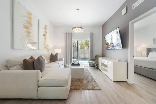 a living room with furniture and a large window