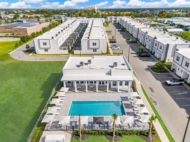 a view of an house with swimming pool and porch with furniture