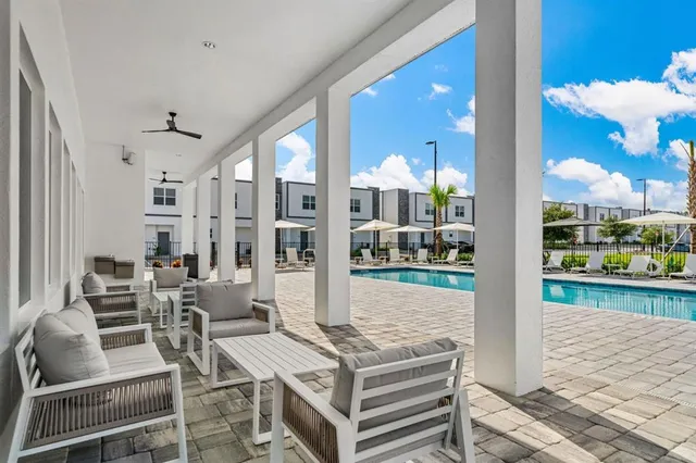 a view of a house with a big yard and large tree