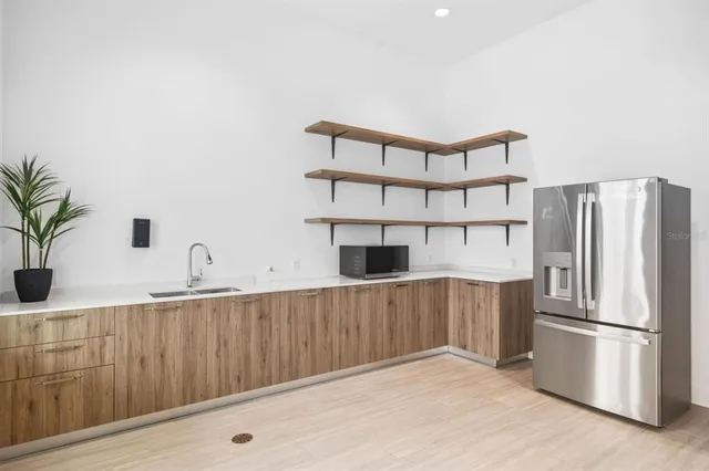 a view of a dining room with furniture a rug and wooden floor
