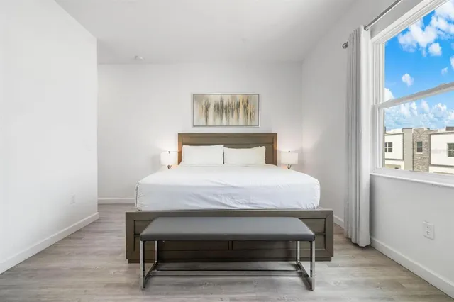 a bedroom with a bed and a window