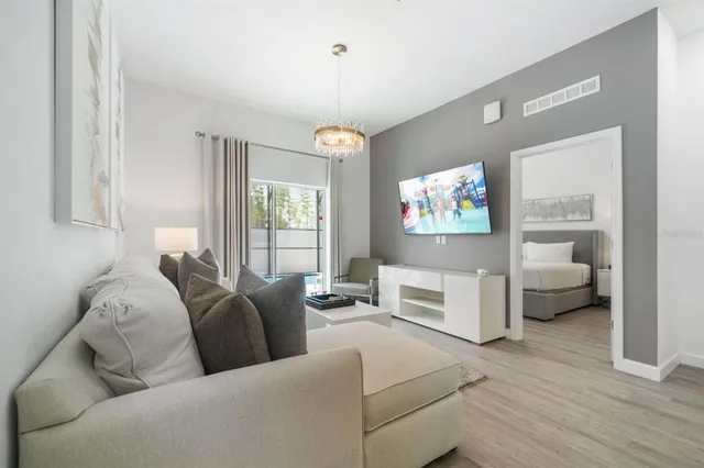 a living room with furniture and a chandelier