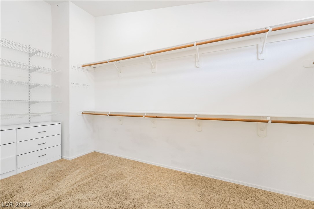 271 Pointe Ranier Avenue Henderson, NV 89012 - Photo 16 of 26 This spacious walk-in closet features ample storage and organizational solutions.