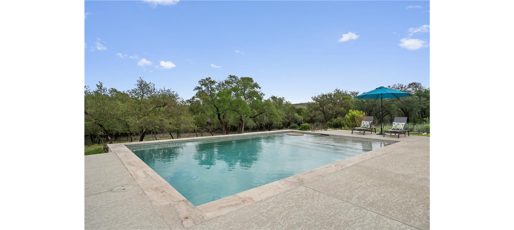 1805 Performer Road Spicewood, TX 78669 - Photo 30 of 40 a view of a swimming pool with outdoor seating