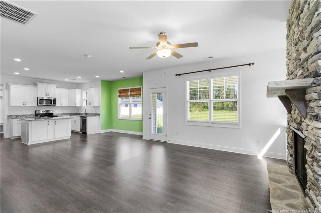 176 Josey Williams Road Erwin, NC 28339 - Photo 12 of 40 a view of an empty room with kitchen and a window
