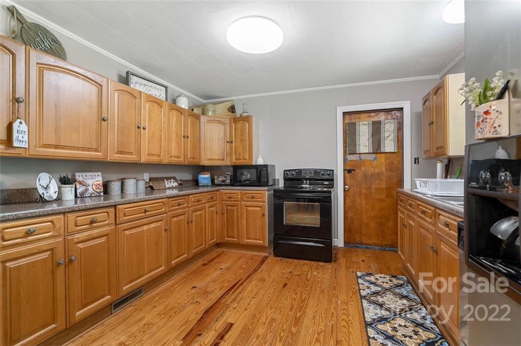 1167 Stringfellow Road Chester, SC 29706 - Photo 8 of 25 a kitchen with stainless steel appliances granite countertop a stove and a refrigerator