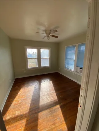 wooden floor in an empty room with a window