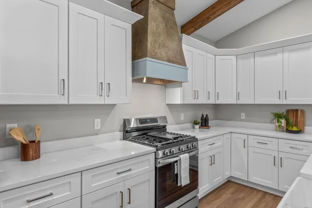 a kitchen with white cabinets and white appliances