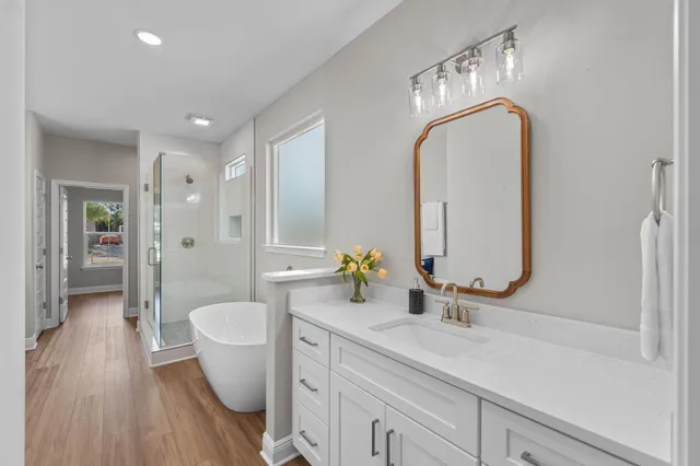a bathroom with a double vanity sink mirror and toilet