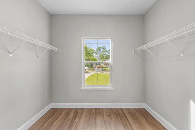 a view of room with window and wooden floor