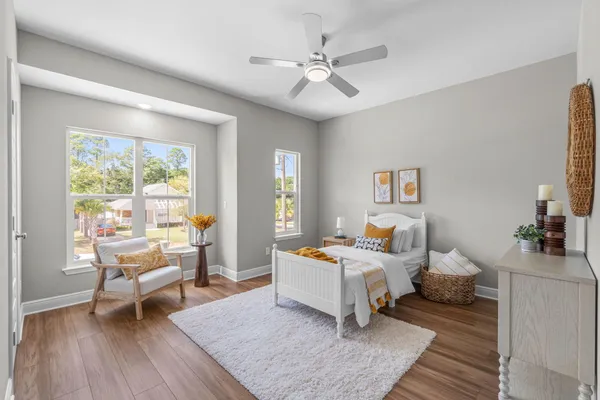a bedroom with a bed and wooden floor