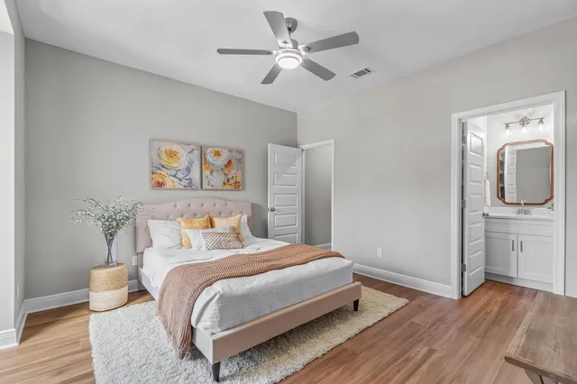 a bedroom with a bed and wooden floor