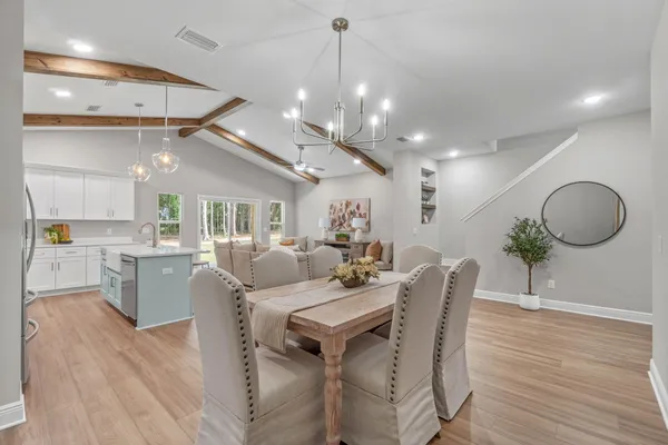 a view of a dining room with furniture wooden floor and chandelier