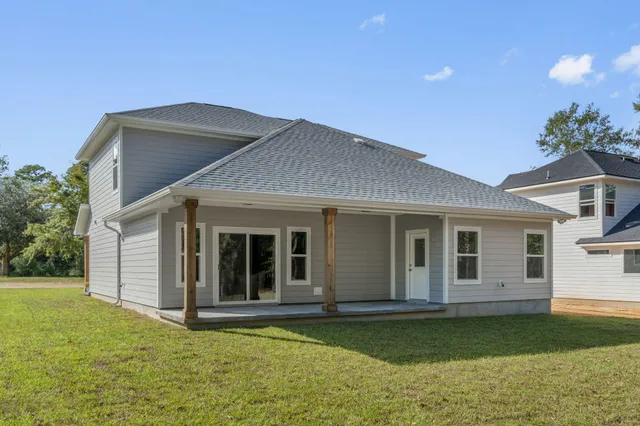 a view of a house with swimming pool and a yard